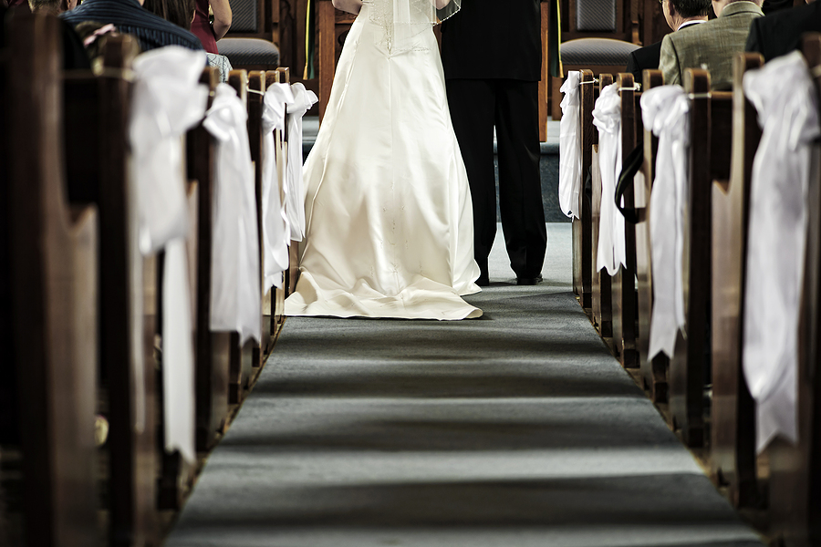 Bride and groom getting married in view from aisle Bold Vision Financial